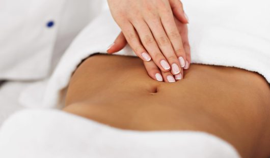 Picture of beautiful woman getting massage in spa