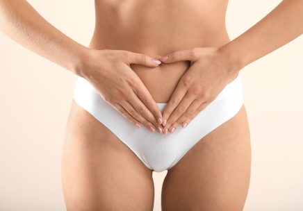Young woman on light background, closeup. Gynecology concept
